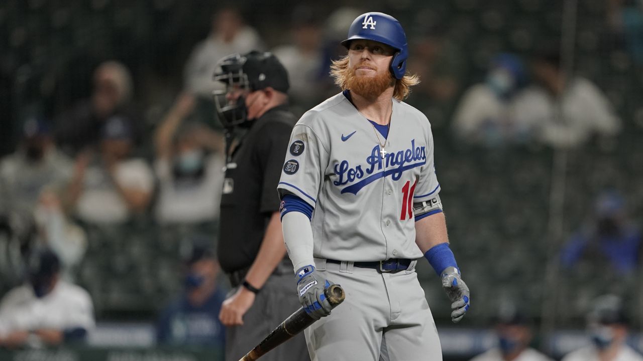 Los Angeles Dodgers' Justin Turner reacts after striking out swinging during the seventh inning of a baseball game against the Seattle Mariners, Monday, April 19, 2021, in Seattle. (AP Photo/Ted S. Warren)