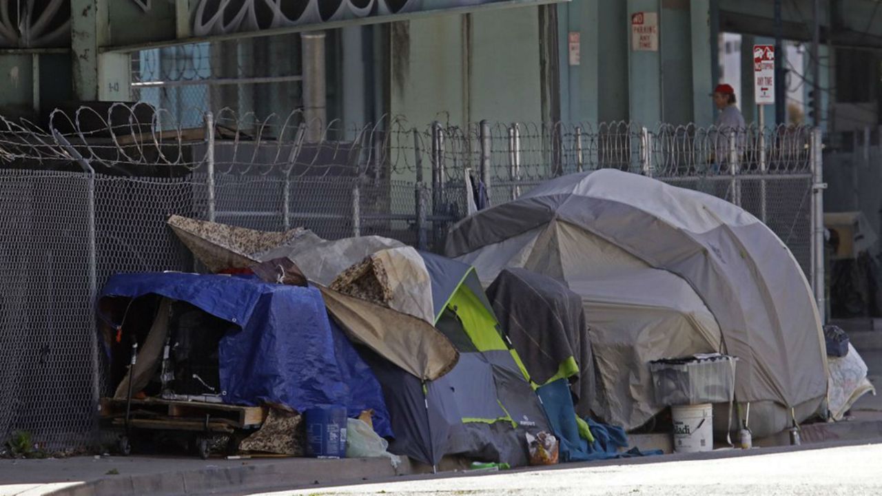 Homeless encampment seen on Monday, April 13, 2020, in San Francisco. Local governments have begun moving large numbers of homeless into hotels as part of Operation Roomkey. Among the requirements are that people get tested when they check in and that medical staff at the hotel make regular checks to see if people's conditions change. (AP Photo/Ben Margot)