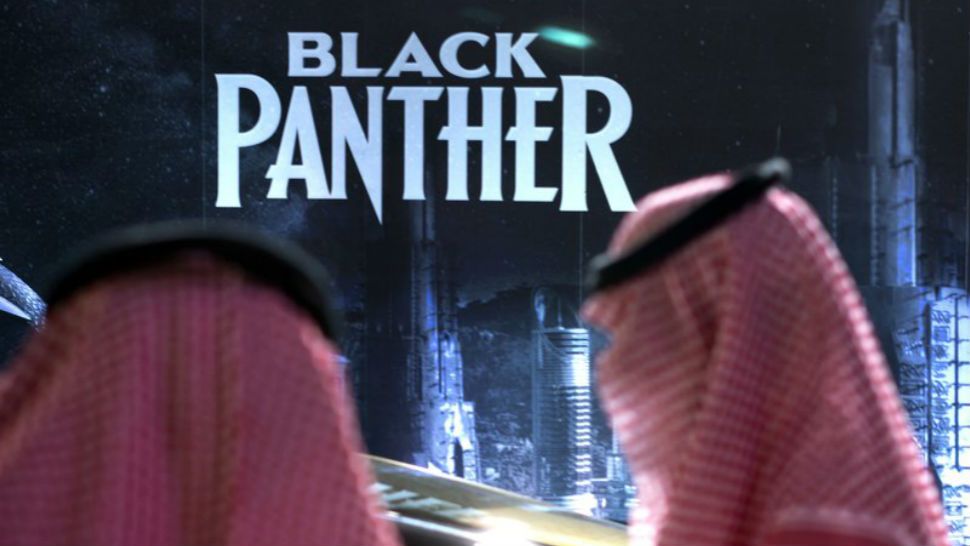 Visitors wait in front of a “Black Panther” movie banner, during an invitation-only screening, at the King Abdullah Financial District Theater, in Riyadh, Saudi Arabia, Wednesday, April 18, 2018. Saudi Arabia held a private screening of the Hollywood blockbuster “Black Panther” Wednesday, to herald the launch of movie theaters that are set to open to the public next month. (AP Photo/Amr Nabil)