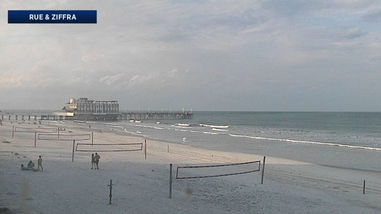 A few beachgoers hang out on a warm Sunday evening at an otherwise deserted Daytona Beach. (Sky 13 weather camera)