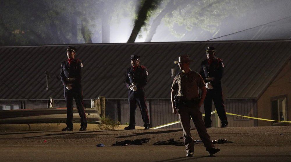 An honor guard stand at the scene where a man shot a and killed a San Marcos police officer and wounded two others, authorities said Saturday, April 18, 2020, in San Marcos, Texas. (AP Photo/Eric Gay)