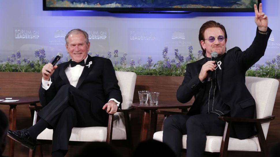 Former President George W. Bush, left, and U2 musician Bono participate in a Q&A session during a gala for the Forum on Leadership at the George W. Bush Institute, Thursday, April 19, 2018, in Dallas. President Bush presented Bono with a medal of Distinguished Citizenship. (AP Photo/Brandon Wade)