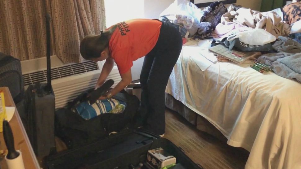 A woman unpacks at a hotel in April that she was staying at using FEMA assistance. A judge ruled Thursday that FEMA assistance for Puerto Rican evacuees must end. (File)