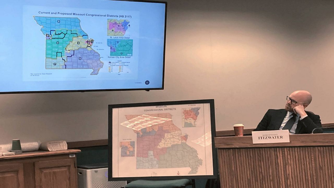 Missouri state Rep. Travis Fitzwater studies a proposed map of U.S. House districts during a state House committee hearing on Jan. 10, 2022, at the state Capitol in Jefferson City, Mo. The Missouri House and Senate have been unable to reconcile competing maps. (AP Photo/David A. Lieb, File)