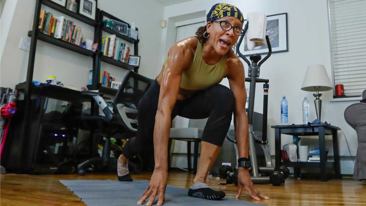 Fitness instructor Tamara Jackson teaches a fitness class through Zoom, an online meeting platform, Saturday, April 25, 2020, in New York. (AP Photo/Frank Franklin II)