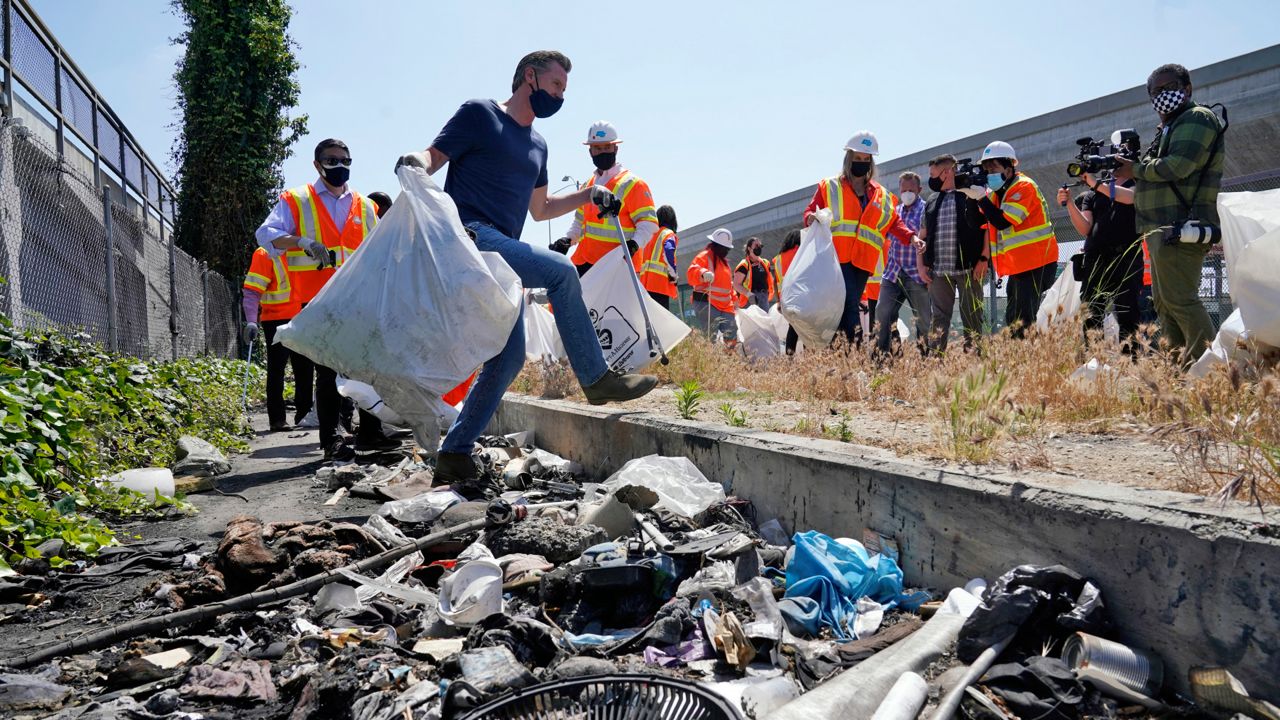 In this May 11, 2021, file photo, California Gov. Gavin Newsom joins a cleanup effort in Los Angeles. (AP Photo/Marcio Jose Sanchez, File)
