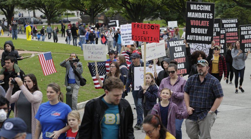 Protesters rally at the Texas State Capitol to speak out against Texas' handling of the COVID-19 outbreak, in Austin, Texas, Saturday, April 18, 2020. Austin and many other Texas cities remain under stay-at-home orders due to the COVID-19 outbreak except for essential personal. (AP Photo/Eric Gay)