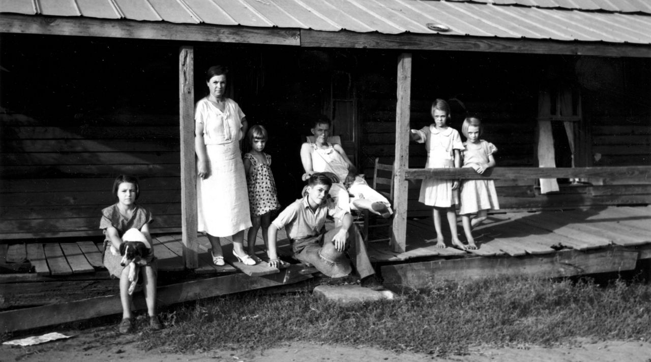 This is an undated photo of a sharecropper's family on the front porch of their home in Monroe County, Ga., during the Great Depression. Left to right are Marie Mask, Mrs. Dessa Mask, Thelma Mask, Glynn Mask, E.T. Mask, Imogene Mask, and Frances Mask. (AP Photo)
