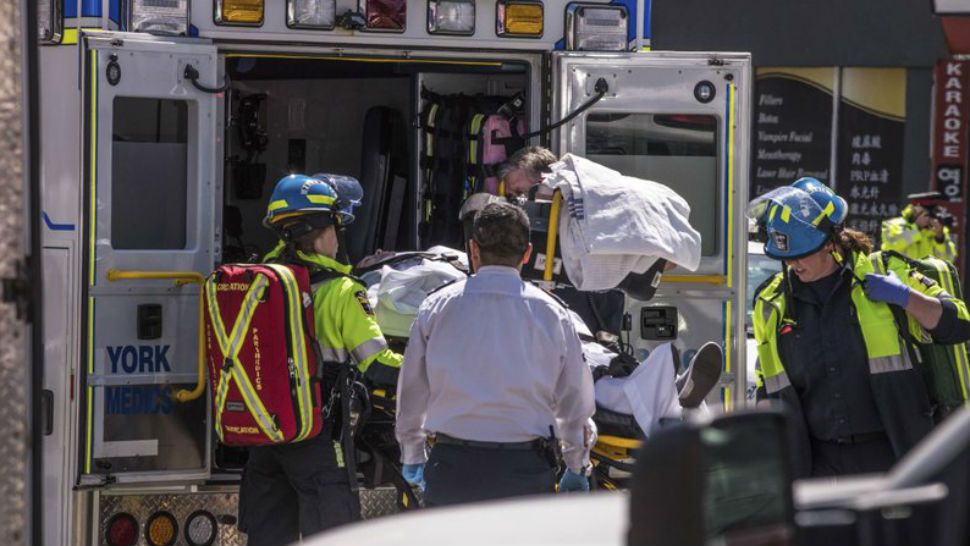 A injured person is put into the back of an ambulance in Toronto after a van mounted a sidewalk crashing into a crowd of pedestrians on Monday, April 23, 2018. The van apparently jumped a curb Monday in a busy intersection in Toronto and struck the pedestrians and fled the scene before it was found and the driver was taken into custody, Canadian police said. (Aaron Vincent Elkaim/The Canadian Press via AP)