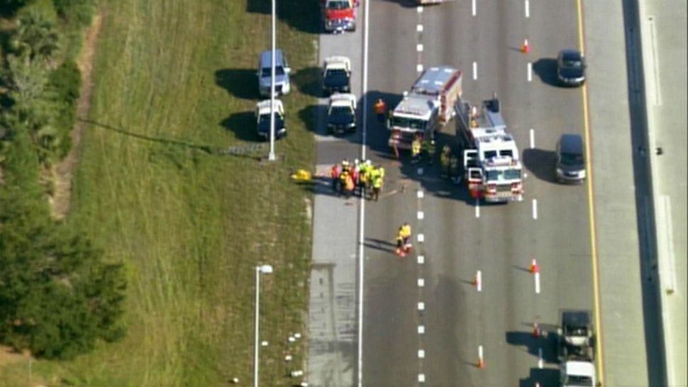 Orange County Fire Rescue firefighters respond to the scene of a crash on Florida's Turnpike near Interstate 4 on Wednesday morning after barrels of calcium chloride spilled onto the road. (Sky 13)