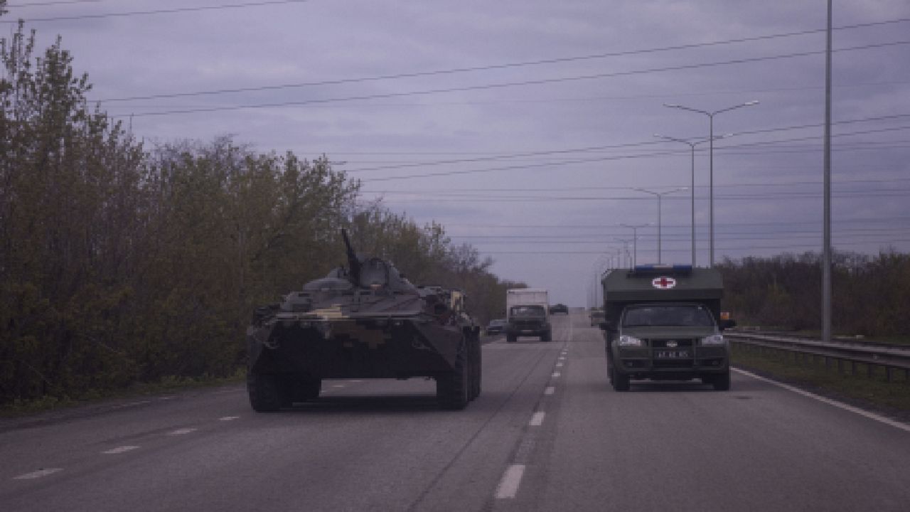 A Ukrainian armored vehicle and a military ambulance, right, move on a road in Donetsk region, eastern Ukraine, Saturday, April 23, 2022. (AP Photo/Evgeniy Maloletka)
