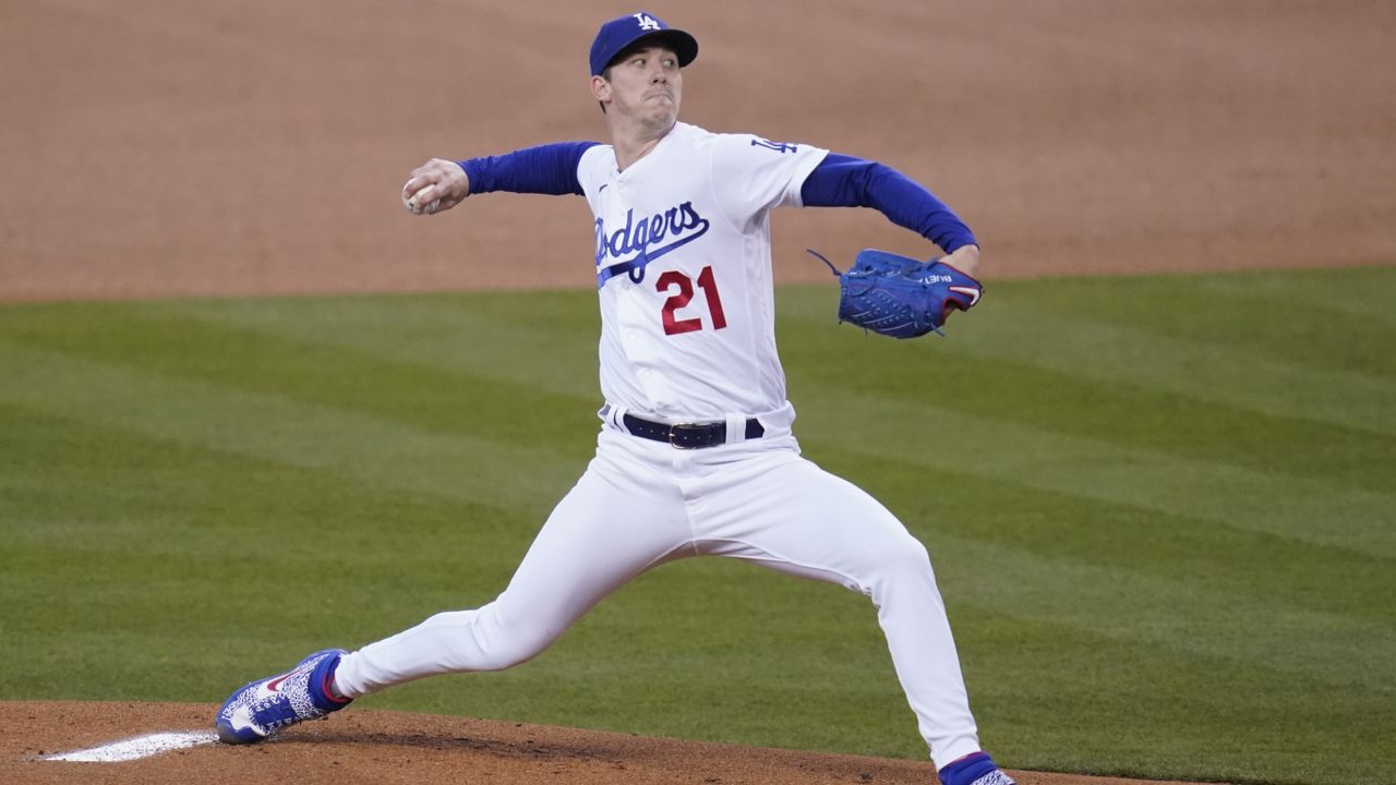 Los Angeles Dodgers starting pitcher Walker Buehler (21) throws during the first inning of a baseball game against the Cincinnati Reds Tuesday, April 27, 2021, in Los Angeles. (AP Photo/Ashley Landis)