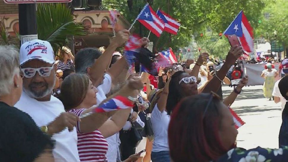 Puerto Ricans during parade holding Puerto Rico flags