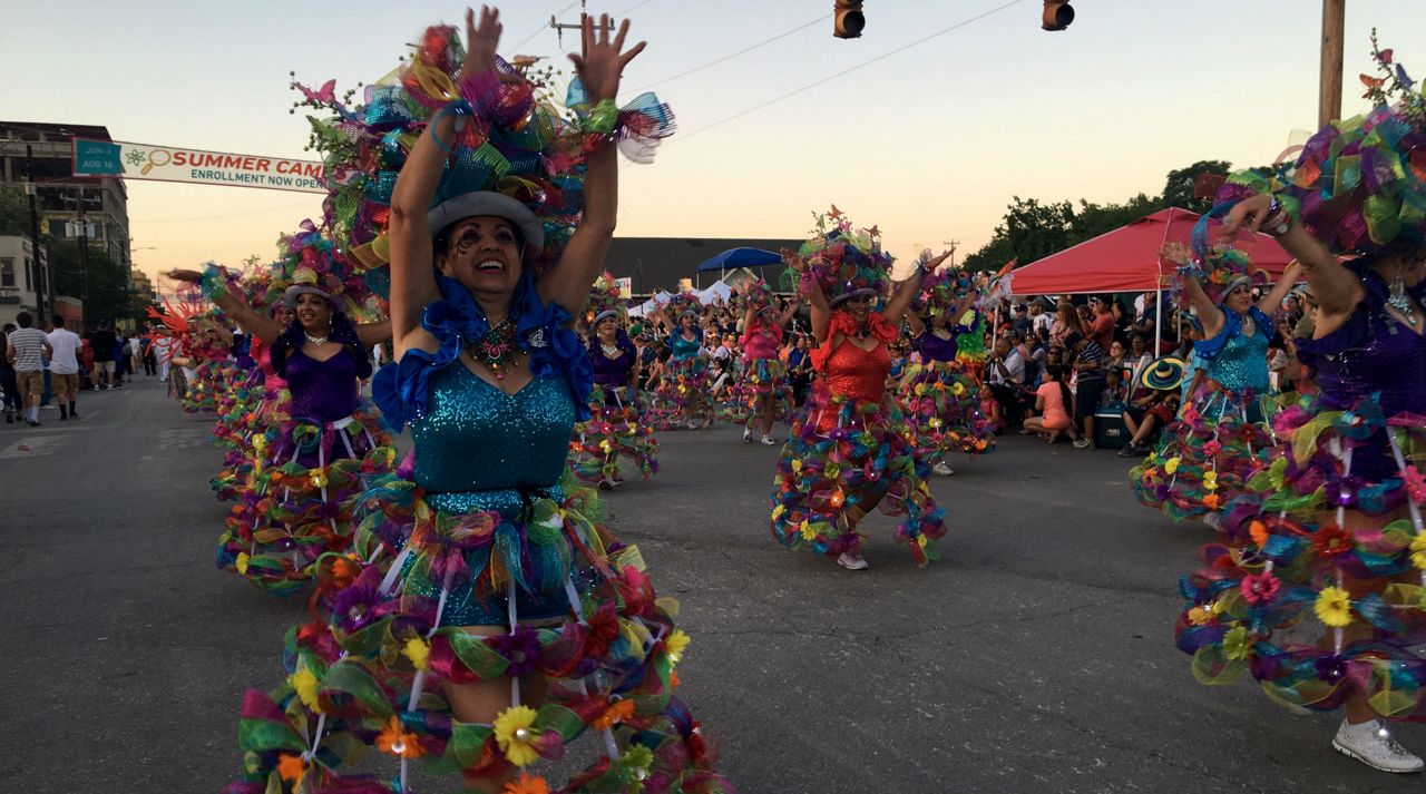 Women dressed in lights and Fiesta attire for the annual Fiesta Flambeau Parade April 27, 2019 (Spectrum News)