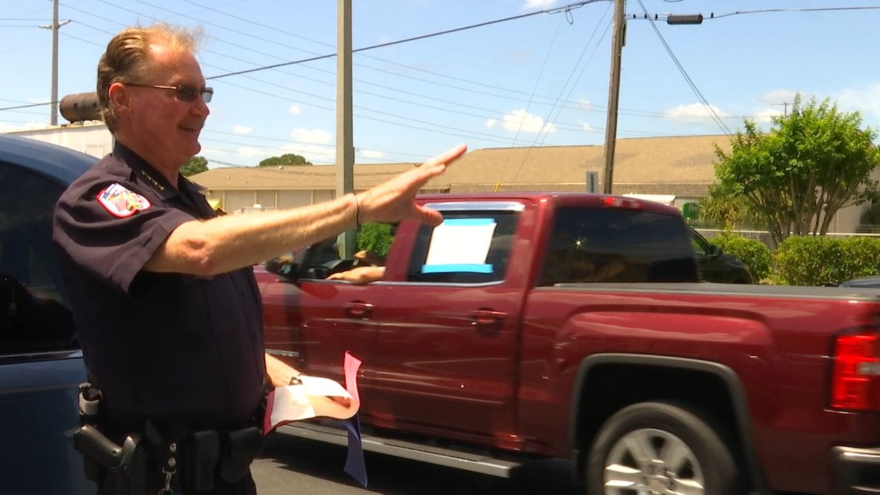 Neighbors, firefighters and fellow officers all came out to surprise Police Chief Gerard DeCanio at City Hall on Wednesday, to thank him for his service. (Tim Wronka/Spectrum Bay News 9)