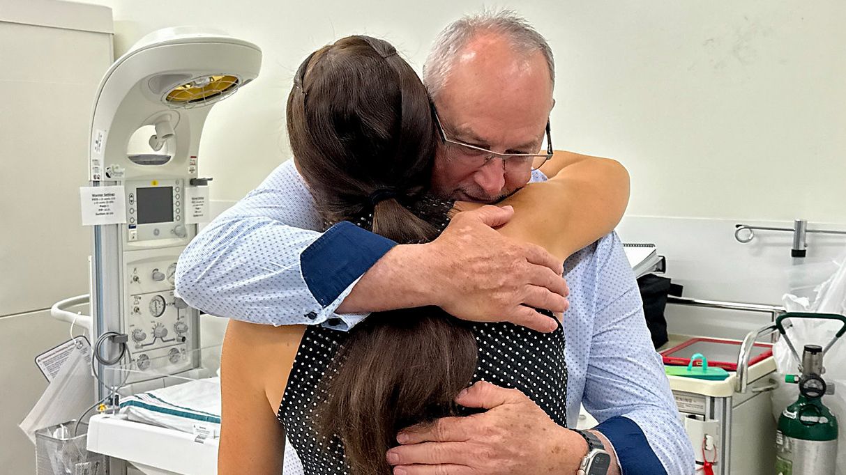 Paul Battle hugs an ER doctor that played a role in saving his life. (Spectrum Bay News 9/Erin Murray)