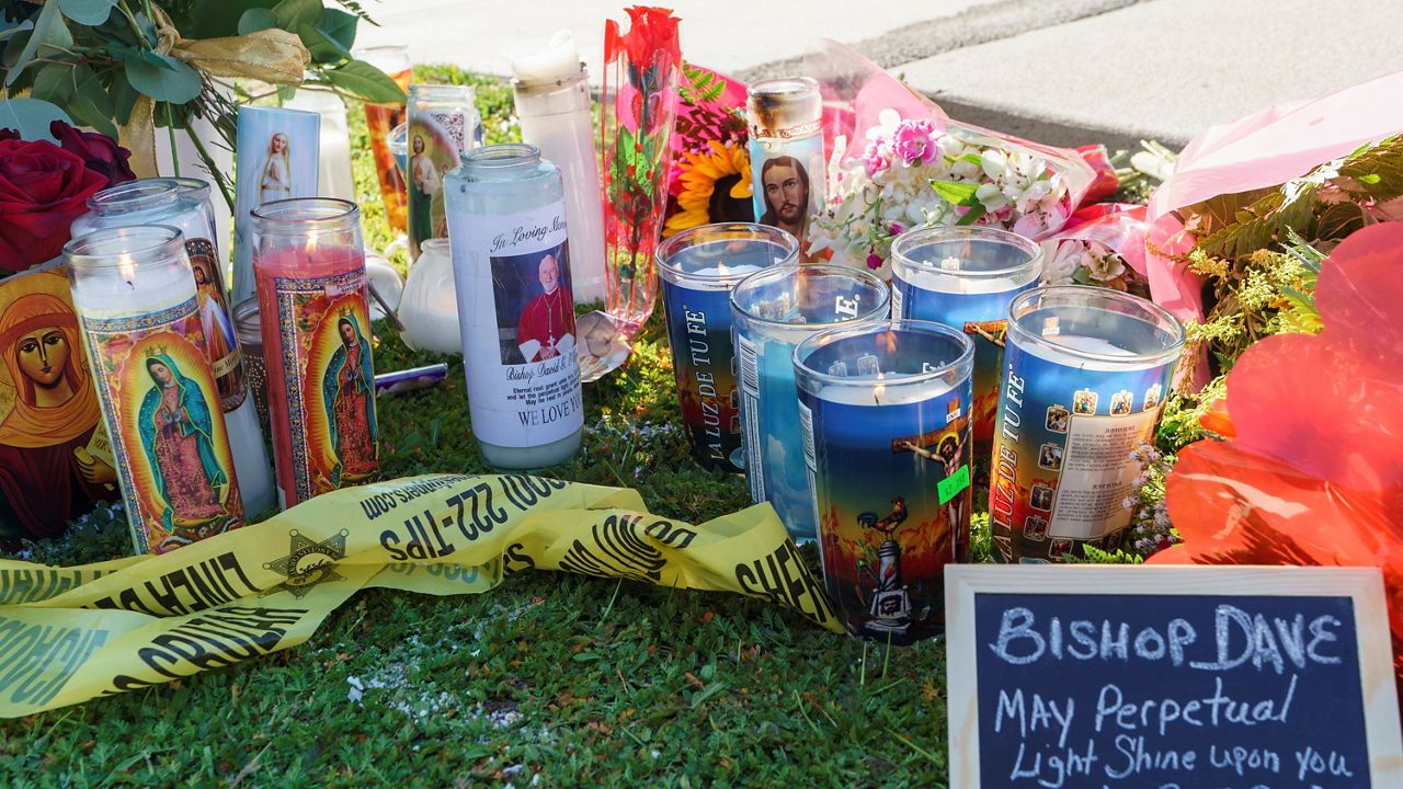 Candles and messages are left near Bishop David O'Connell's residence in Hacienda Heights, Calif., Sunday, Feb. 19, 2023. (AP Photo/Damian Dovarganes)