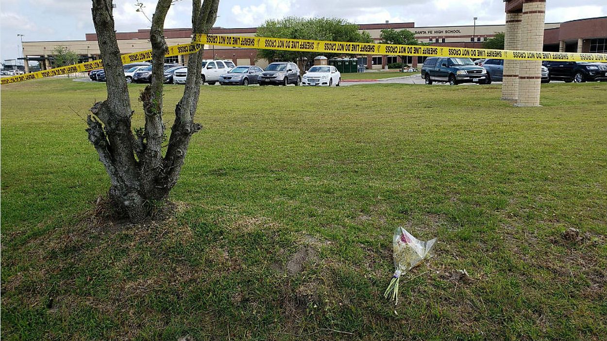 Crime tape and flowers appear outside Santa Fe High School in Santa Fe, Texas, following a mass shooting on May 18, 2018. (Associated Press)