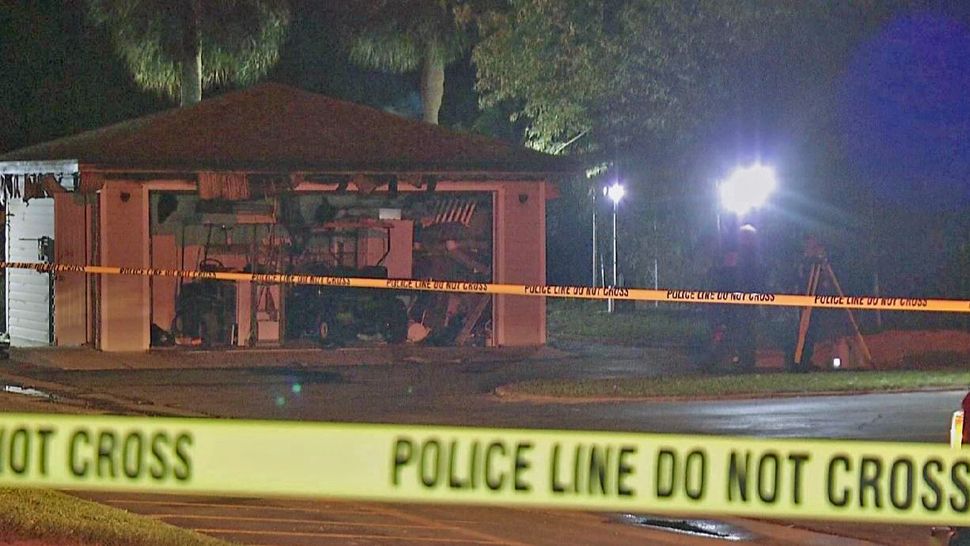 Orlando Police investigate the discovery of a body in a burning vehicle at the Crossroads Apartments on Monday night. (Spectrum News 13)