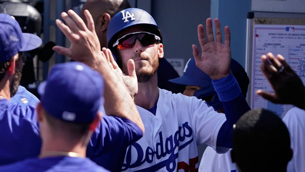 Gavin Lux of the Los Angeles Dodgers looks on from the dugout