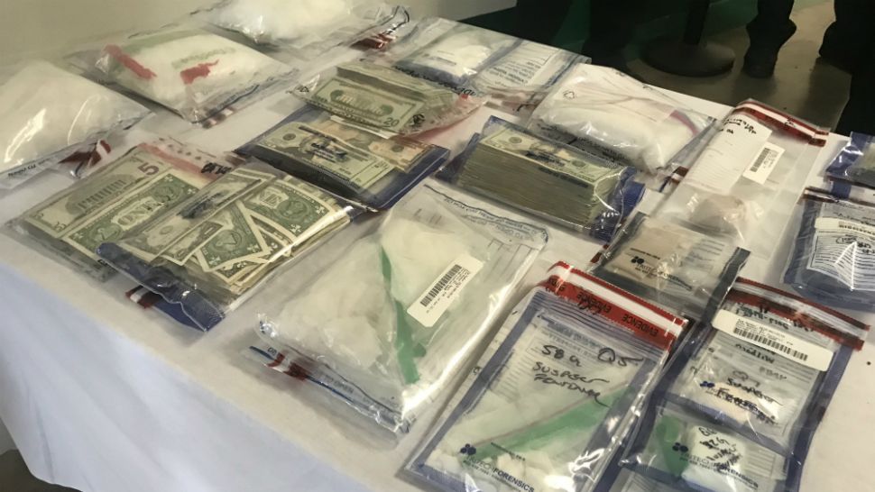 These are some of the drugs, weapons, and cash seized during a massive opioid-trafficking investigation in Brevard County, Sheriff Wayne Ivey said Wednesday. (Greg Pallone/Spectrum News 13)