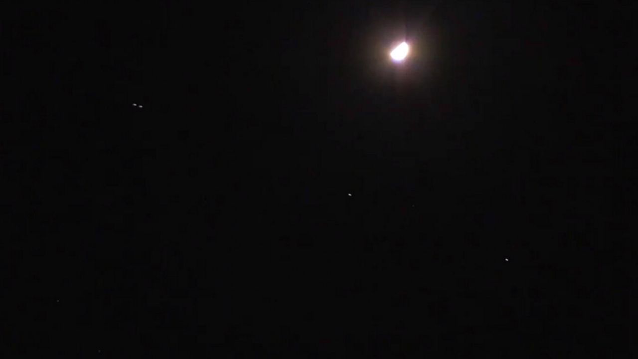 A train of Starlink satellites passes by the moon on the night of April 30. (Jon Shaban/Spectrum News)