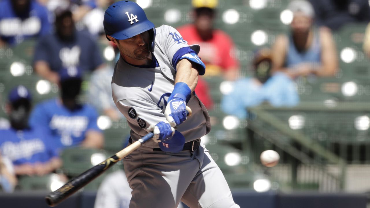 Los Angeles Dodgers' AJ Pollock hits a grand slam during the first inning of a baseball game against the Milwaukee Brewers Sunday, May 2, 2021, in Milwaukee. (AP Photo/Aaron Gash)