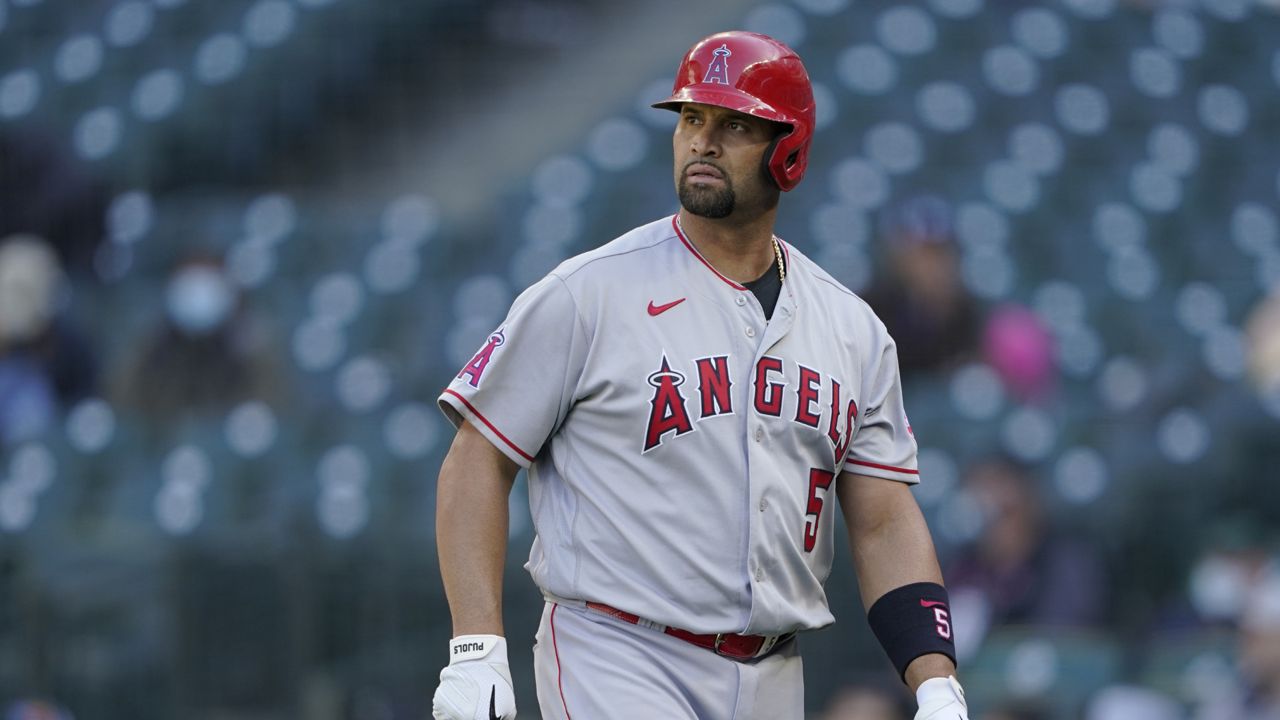Los Angeles Angels Albert Pujols walks to the dugout after he was called out on strikes during the ninth inning of a baseball game against the Seattle Mariners, Sunday, May 2, 2021, in Seattle. (AP Photo/Ted S. Warren)