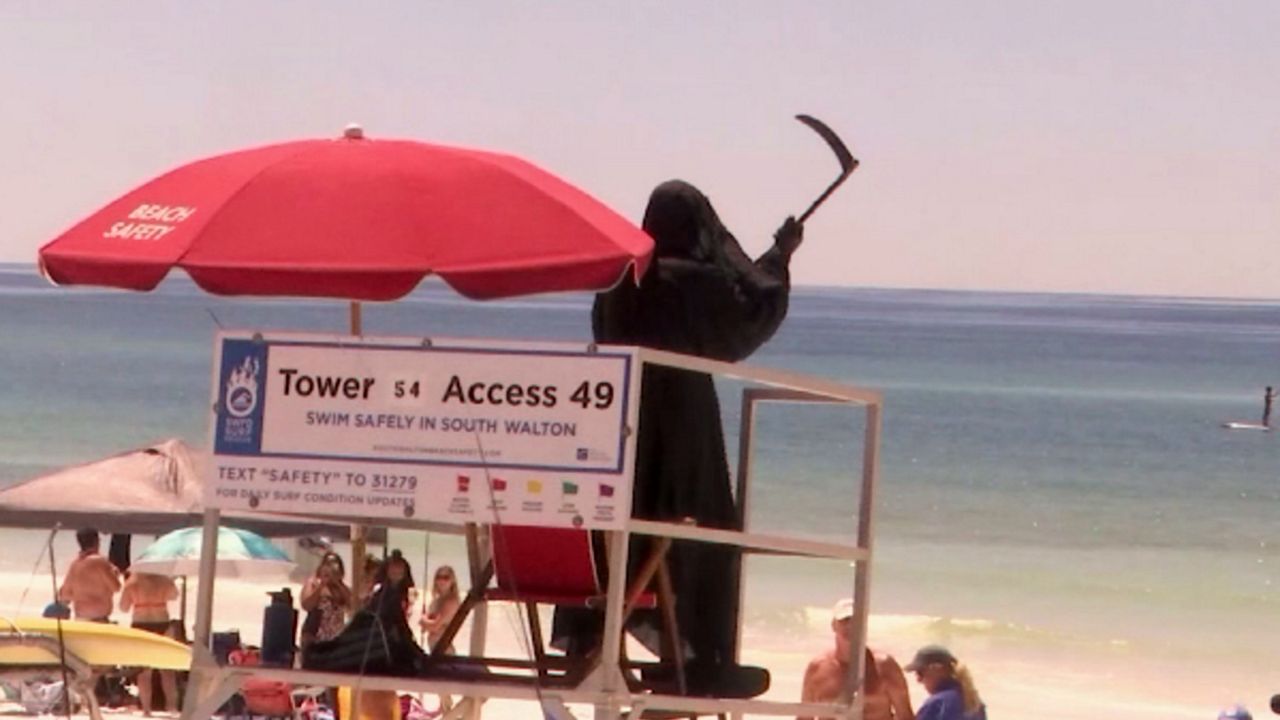 Daniel Uhlfelder, an attorney, is visiting Florida beaches dressed as the Grim Reaper to protest their reopening. (Courtesy of CNN)