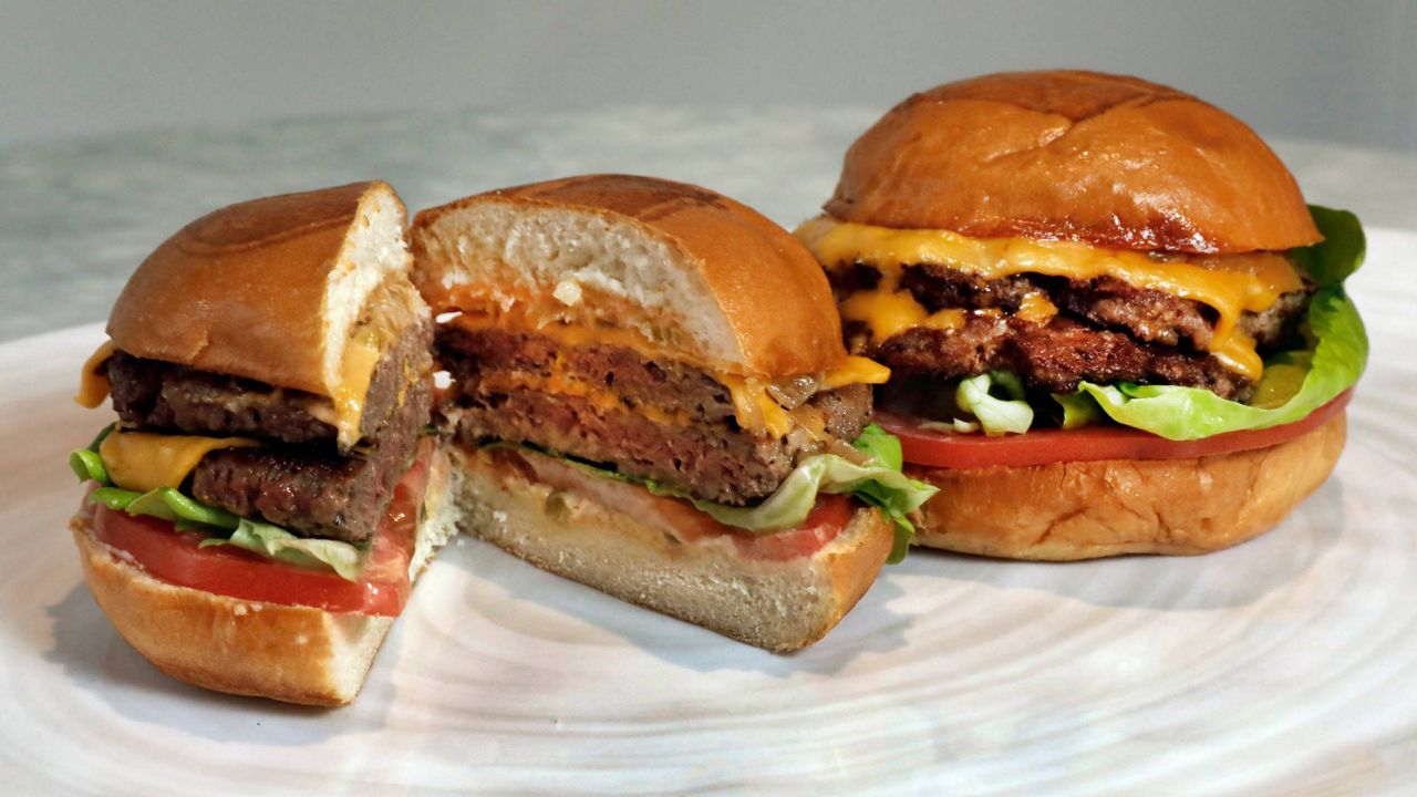 In this May 3, 2019, file photo, an Original Impossible Burger, left, and a Cali Burger, from Umami Burger, are shown in this photo in New York. (AP Photo/Richard Drew)