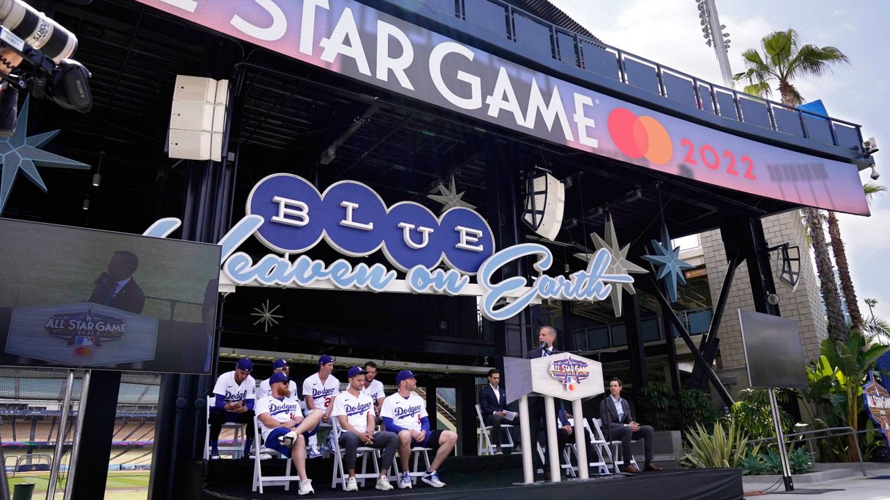 Los Angeles Mayor Eric Garcetti, right, speaks as members of the LA Dodgers look on during an event to officially launch the countdown to MLB All-Star Week Tuesday at Dodger Stadium. (AP Photo/Mark J. Terrill)