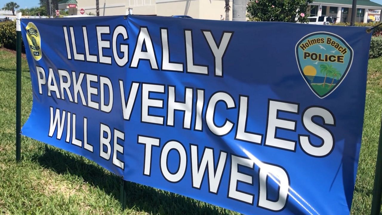 Banners around Anna Maria Island warn people to not park on the street or in neighborhoods within Holmes Beach. (Gabrielle Arzola/Spectrum Bay News 9)