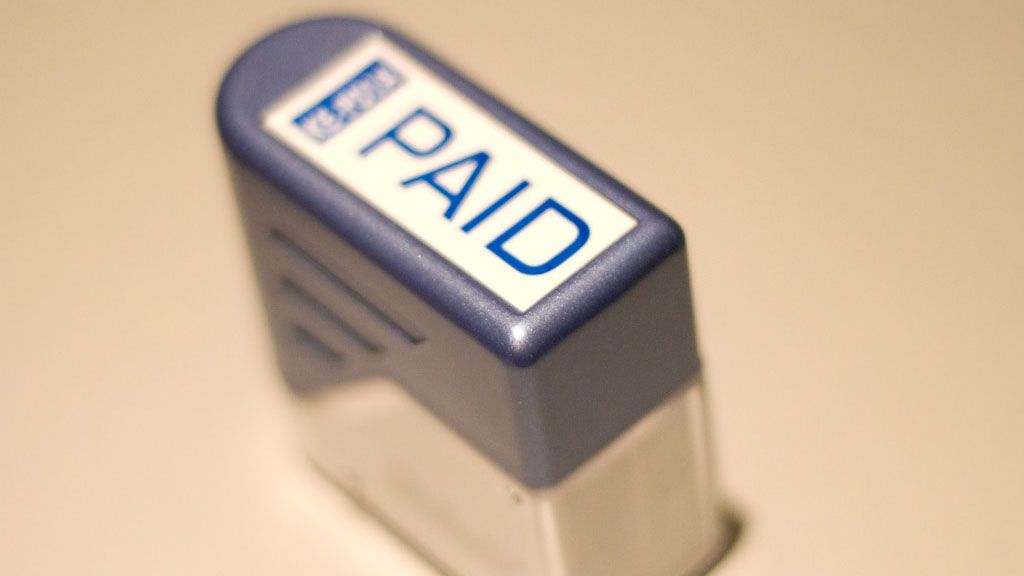 FILE- 'Paid' stamp. Courtesy/Flickr user *_Abhi_*