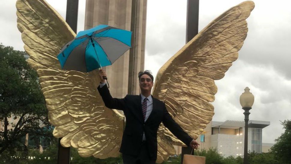 Man poses in front of new sculpture.  Courtesy/Jorge Marín, Facebook