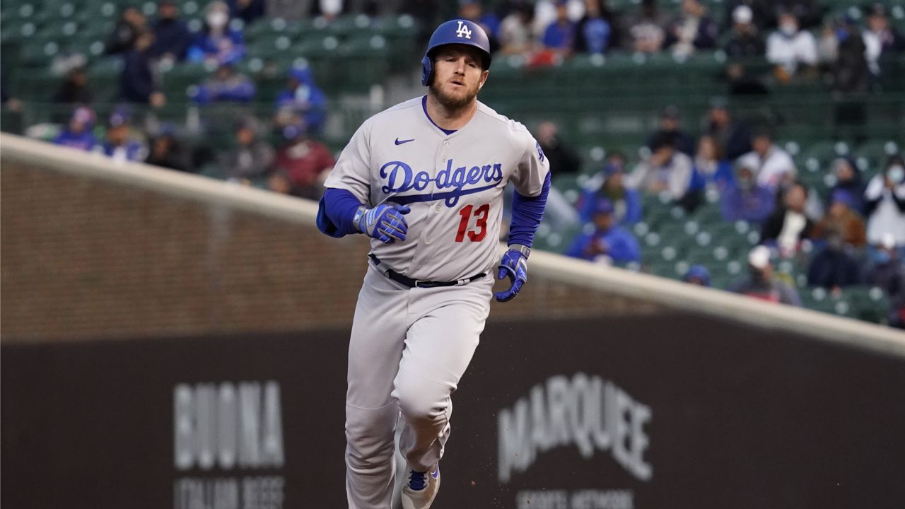 Los Angeles Dodgers' Max Muncy rounds the bases after hitting a solo home run during the fourth inning of a baseball game against the Chicago Cubs in Chicago, Wednesday, May 5, 2021. (AP Photo/Nam Y. Huh)