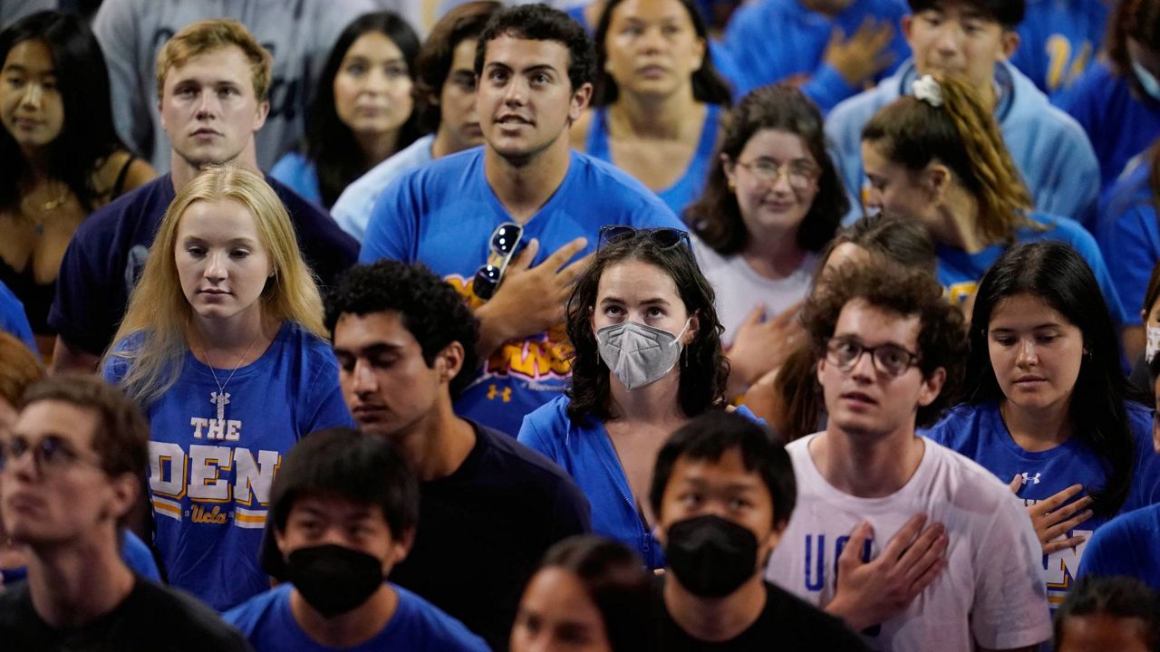 Students listen to the national anthem before a semifinal game in the NCAA men's college volleyball tournament May 5, 2022, in Los Angeles. (AP Photo/Marcio Jose Sanchez)