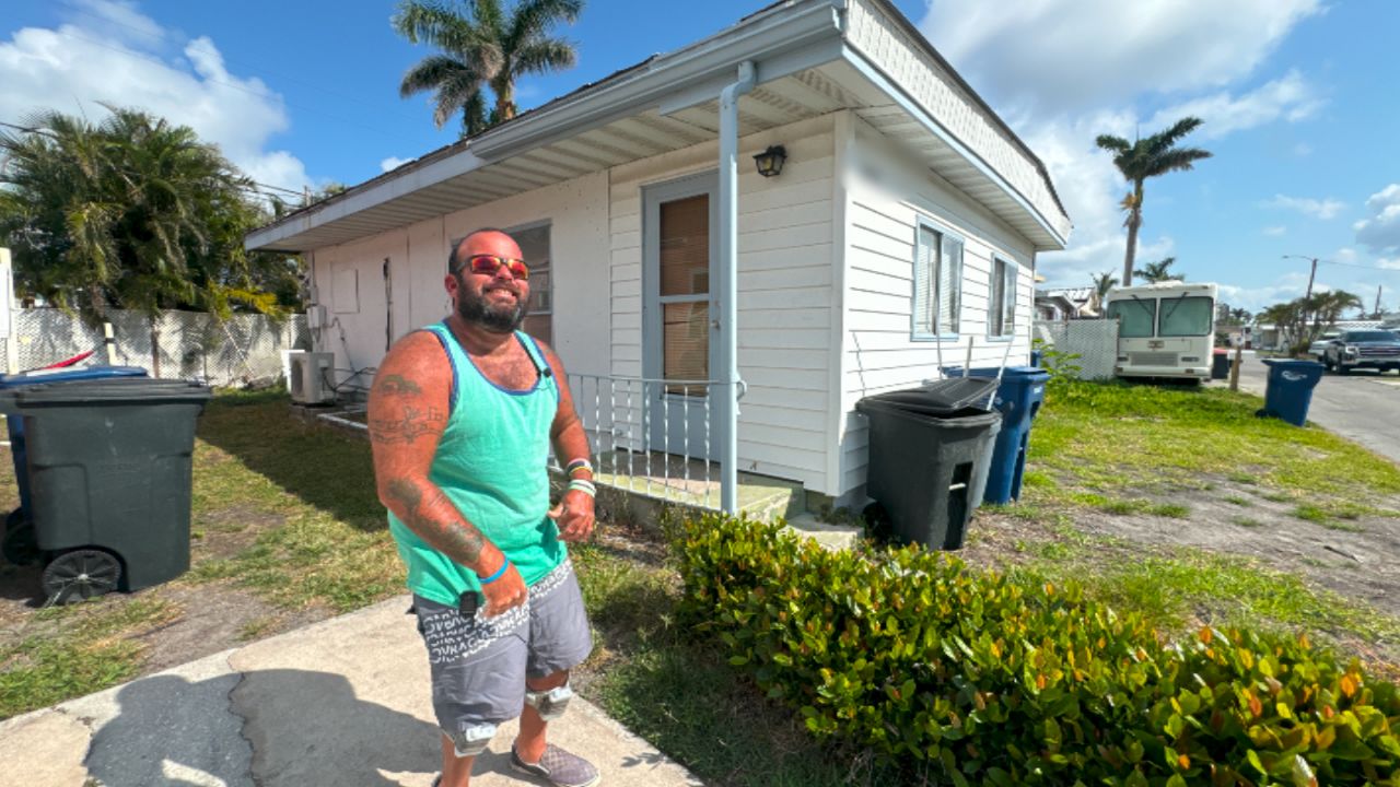 Standing in front of his Sunny Shores home, J.D. White explains how it was flooded during Hurricane Helene. (Spectrum Bay News 9/Julia Hazel)