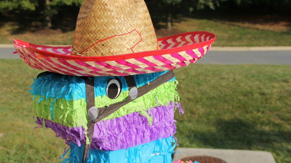 A pinata in a straw hat. 