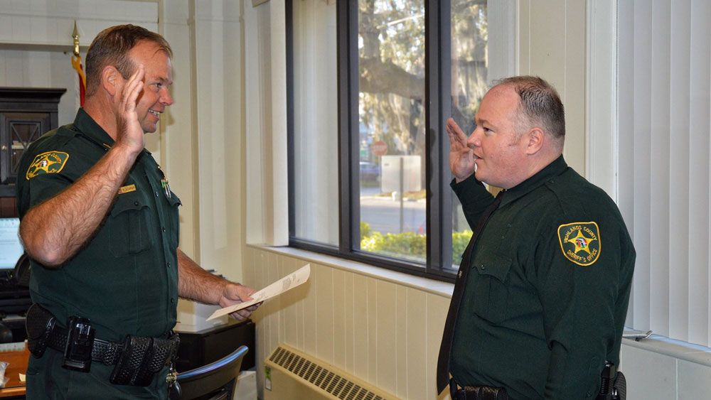 Deputy William Gentry (right) at a ceremony in 2017. Gentry was shot during a neighbor dispute Sunday and died from his injuries Monday. (Highlands County Sheriff's Office)