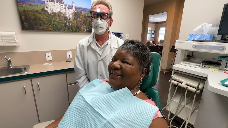 Carol Jarrett, who was able to get dental care thanks to Donated Dental Services, is seen by Dr. Terry Buckenheimer in South Tampa. (Spectrum Bay News 9/Jeff Van Sant/Bay News 9)