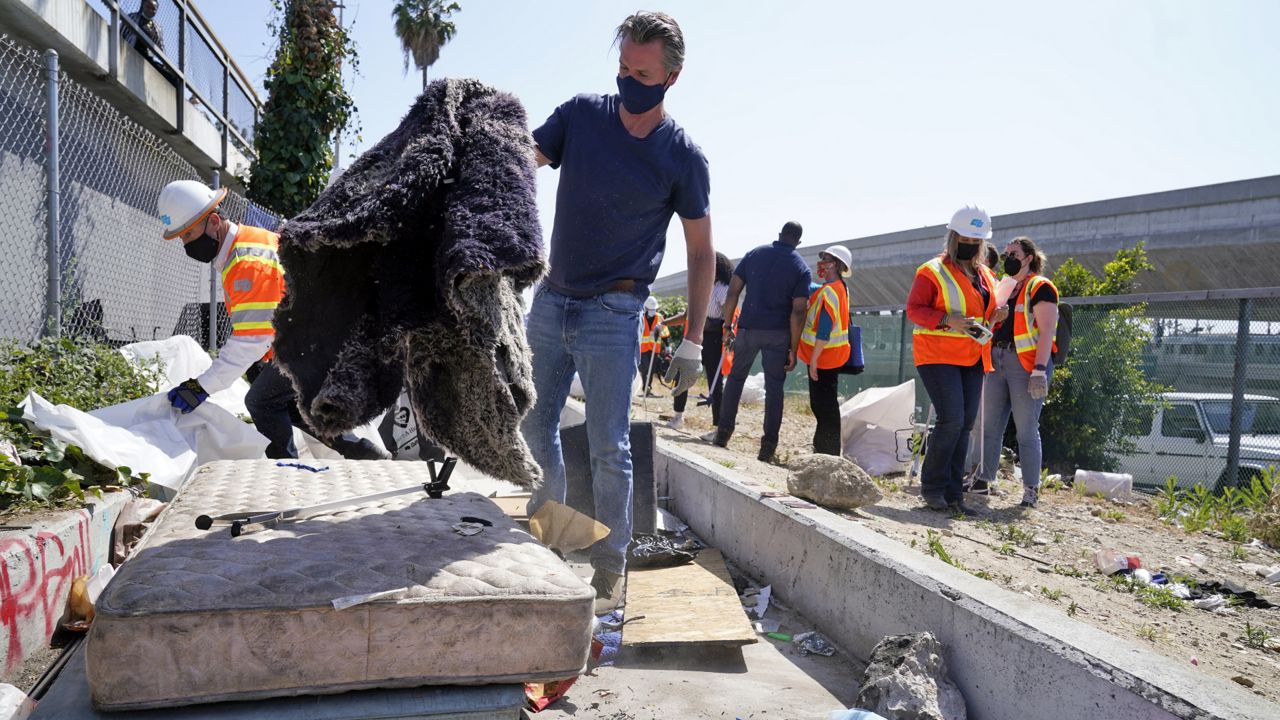 California Gov. Gavin Newsom joins a cleanup effort Tuesday, May 11, 2021, in Los Angeles. (AP Photo/Marcio Jose Sanchez)