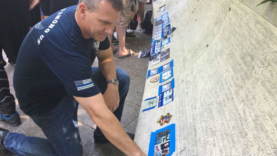 Orlando Police Chief John Mina looks at the memorial wall where Lt. Debra Clayton's name has been added. (Orlando Police Dept./Twitter)