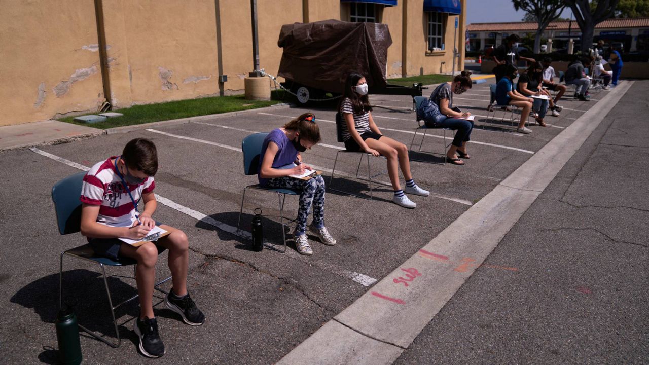 In this May 13, 2021, file photo, children ages 12 to 15 wait to get their vitals checked before getting their Pfizer COVID-19 vaccine at Families Together of Orange County in Tustin, Calif. (AP Photo/Jae C. Hong)