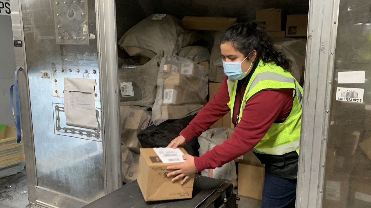 an employee moving boxes at UPS worldport