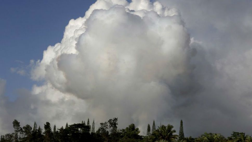 Gases rise from lava fissure 17 after it erupted early Sunday, May 13, 2018, near Pahoa, Hawaii. (AP Photo/Caleb Jones)