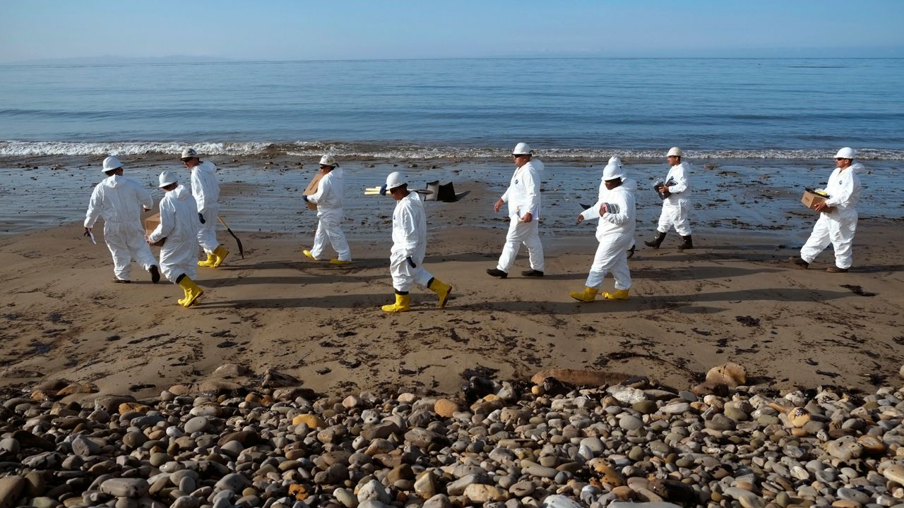 Clean up crews walk down the beach at Refugio State Beach, site of an oil spill, north of Goleta, Calif., Wednesday, May 20, 2015. (AP Photo/Michael A. Mariant)