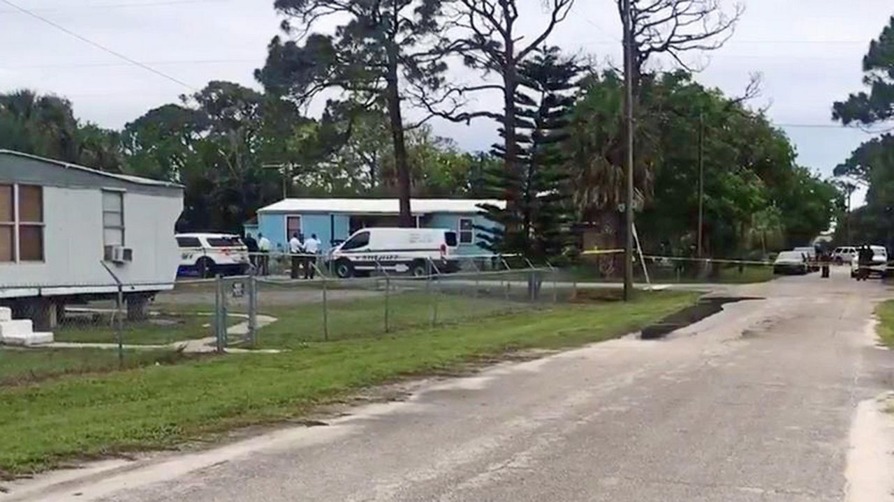 Brevard County deputies responding to a home in Sharpes on Iris Street after a body was found inside a home. (Greg Pallone/Spectrum News 13)