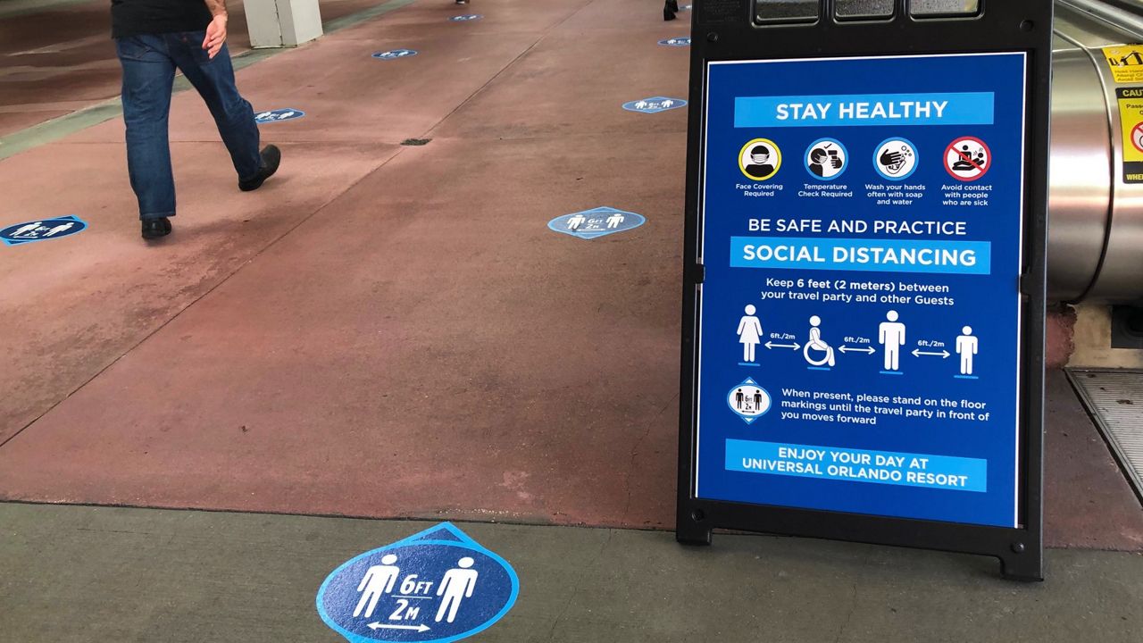 Universal CityWalk at Universal Orlando has reopened with new measures in place to protect people from coronavirus. Signs have been placed around the area to remind visitors of the new rules. (Ashley Carter/Spectrum))
