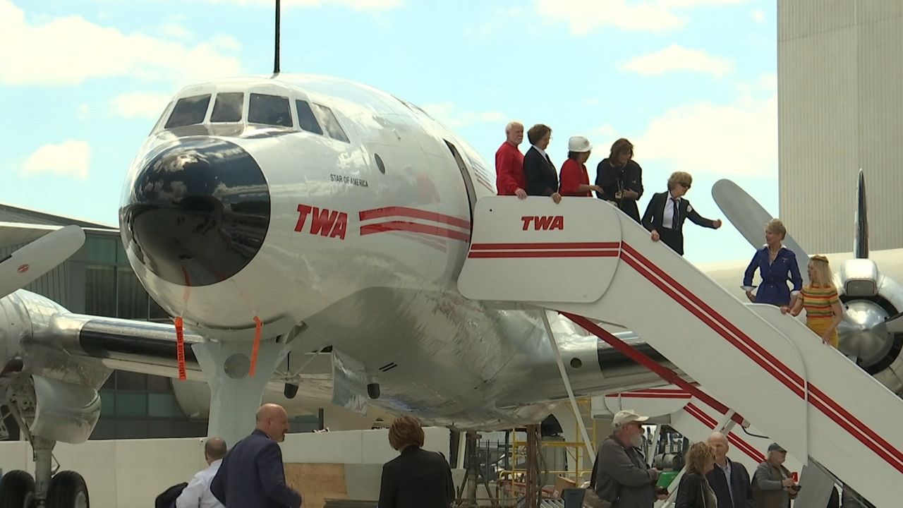 A white plane with white letters near its nose that reads "TWA."