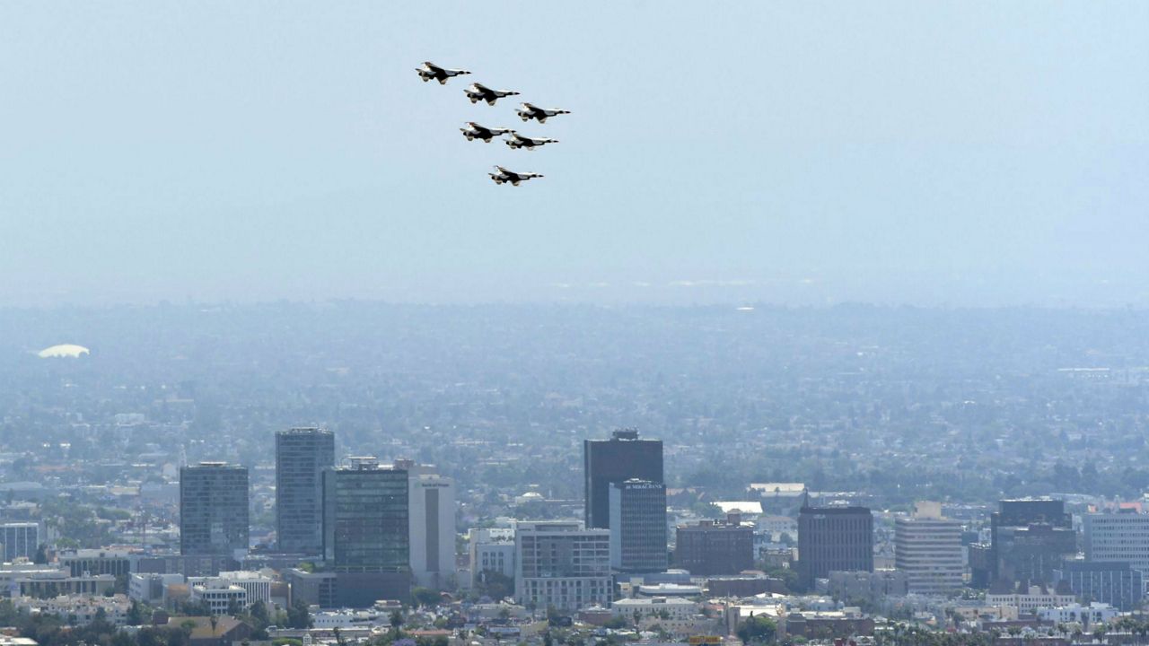 Six F-16C/D Fighting Falcons could be seen flying high above Los Angeles today, as the U.S. Air Force Thunderbirds flew formations over LA and OC counties to honor front-line COVID-19 responders. (AP Photo/Chris Pizzello)